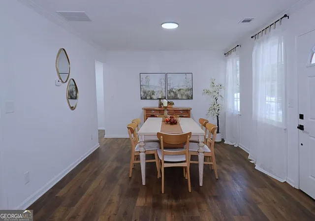 a dining room with furniture and wooden floor