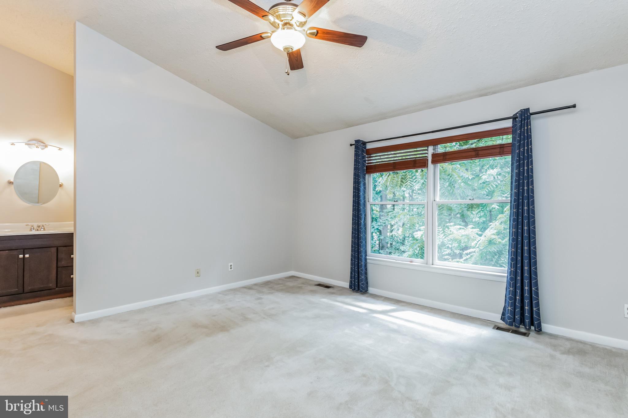1600 Oak Spring Way Reston, VA 20190 - Photo 8 of 19 Primary bedroom w/ vaulted ceilings & ensuite