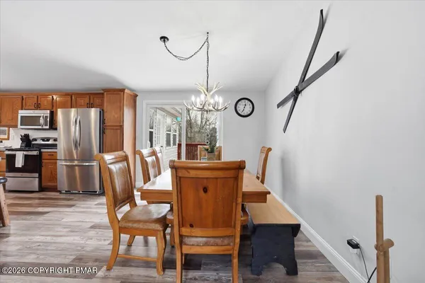 a view of a dining room with furniture window and wooden floor
