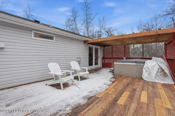 a view of a house with a wooden deck
