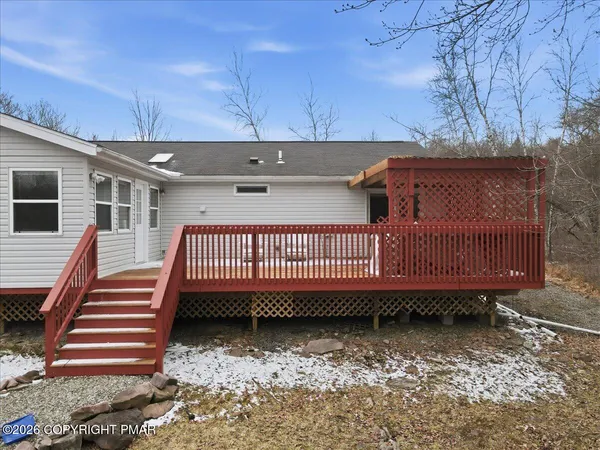 a view of a house with a yard and sitting area
