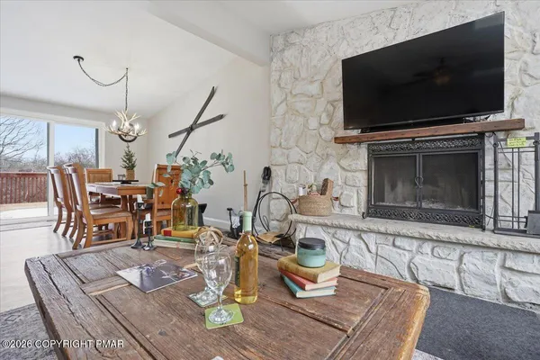 a living room with furniture a flat screen tv and a fireplace