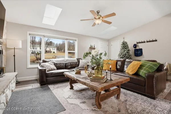 a living room with furniture a large window and a table