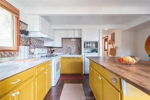 a kitchen with cabinets and wooden floor