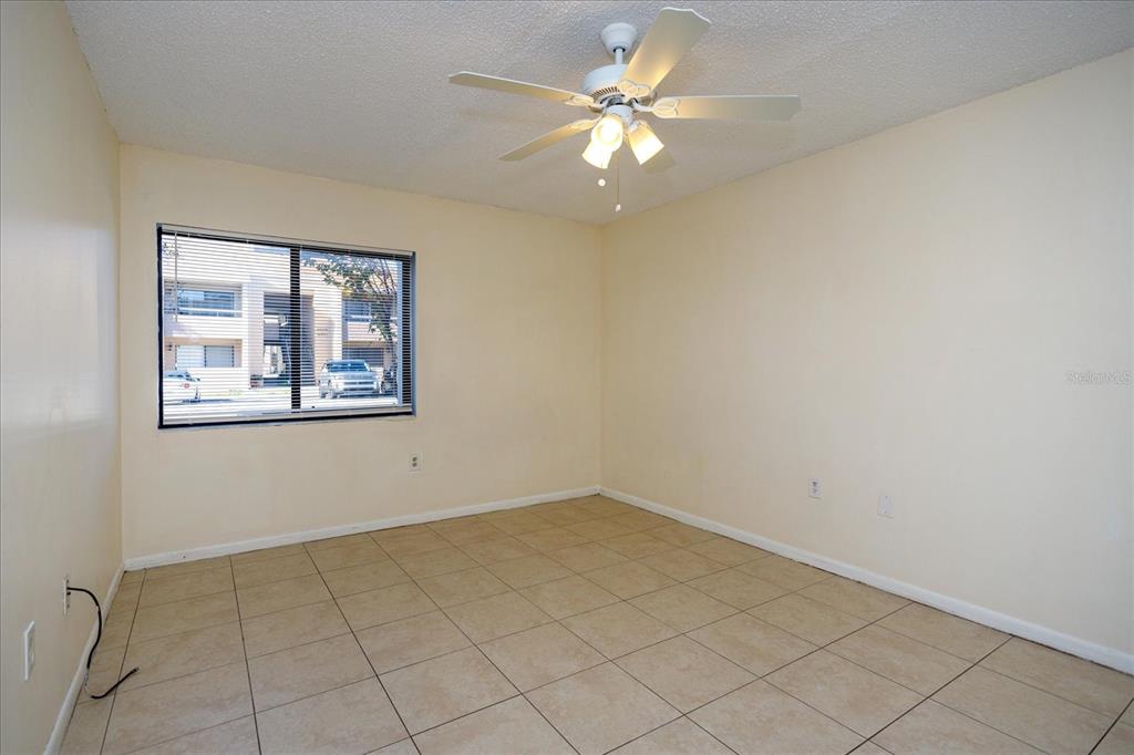 5013 Vineland Road, Unit 108 Orlando, FL 32811 - Photo 11 of 20 an empty room with windows and fan