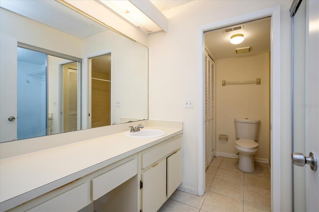 5013 Vineland Road, Unit 108 Orlando, FL 32811 - Photo 14 of 20 a bathroom with a sink a toilet and shower