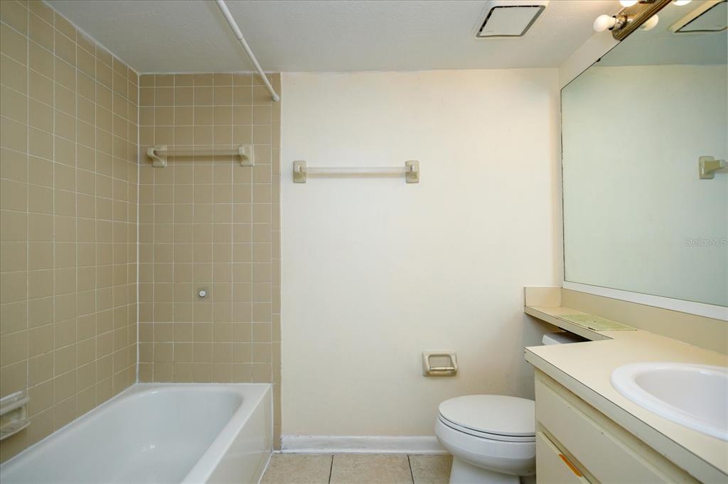 5013 Vineland Road, Unit 108 Orlando, FL 32811 - Photo 19 of 20 a bathroom with a sink a toilet and shower