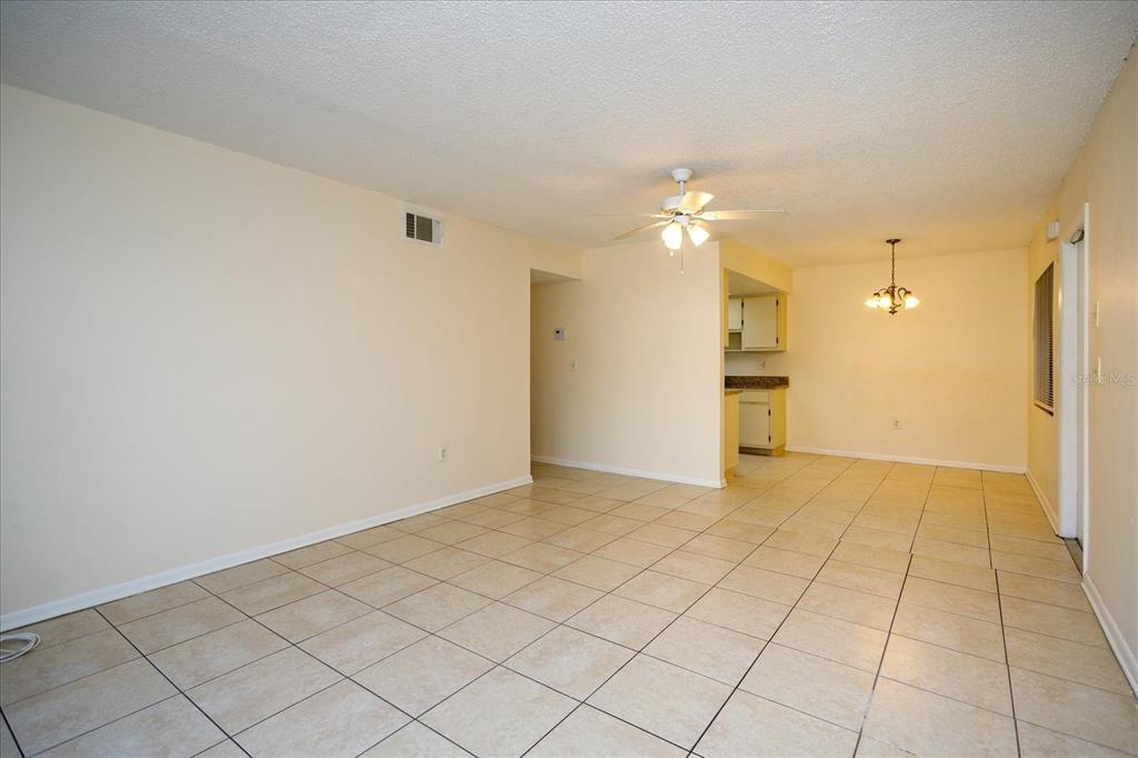 5013 Vineland Road, Unit 108 Orlando, FL 32811 - Photo 6 of 20 a view of an empty room and fire place