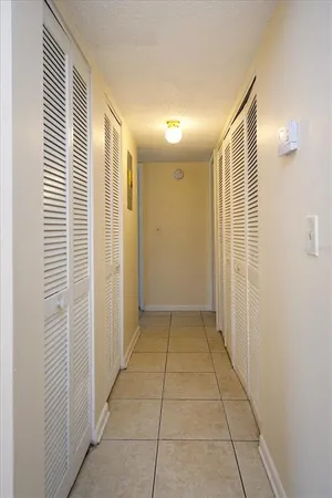 a view of hallway with a shower and closet