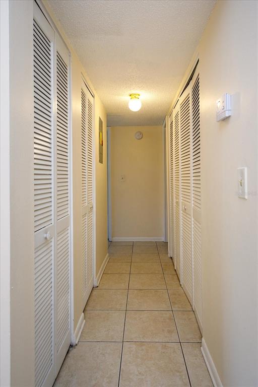 5013 Vineland Road, Unit 108 Orlando, FL 32811 - Photo 9 of 20 a view of hallway with a shower and closet