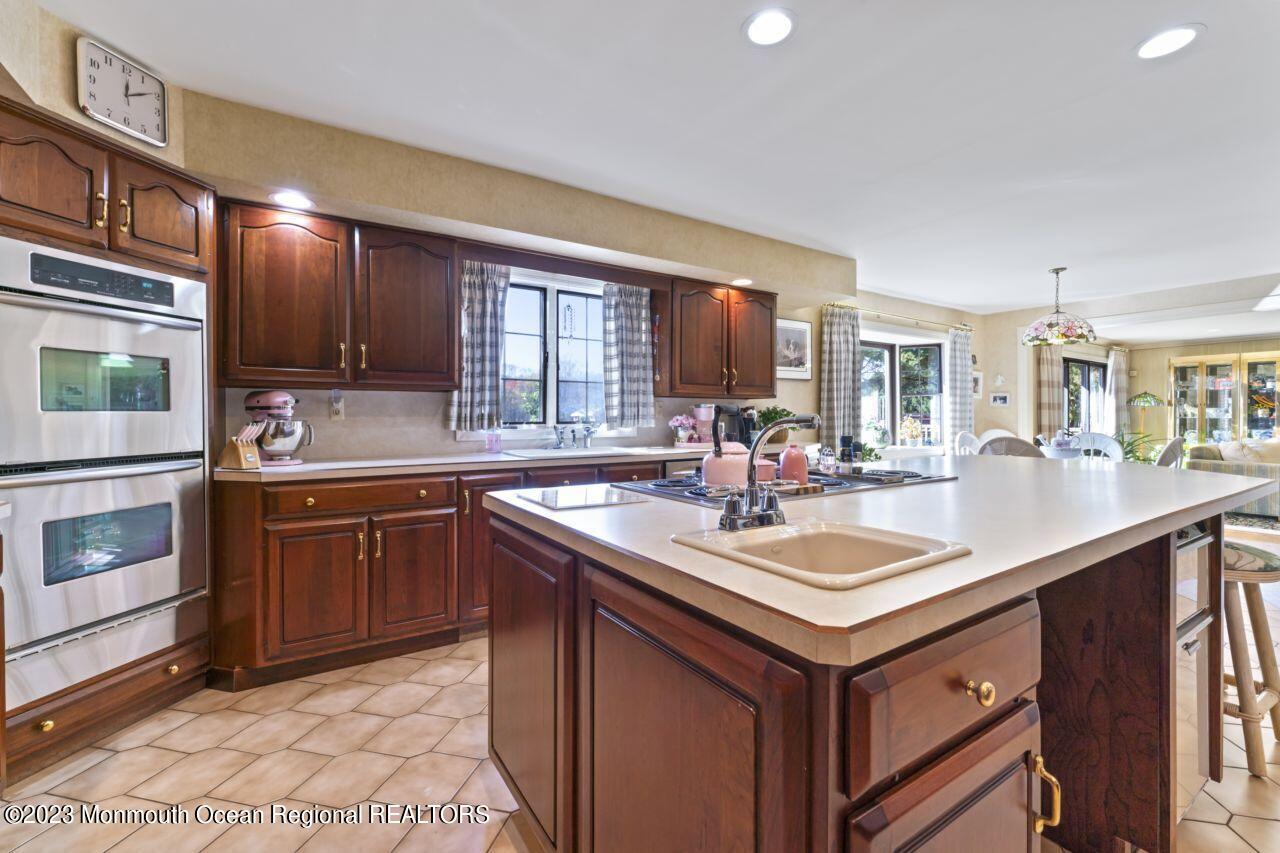 111 Muhlenbrink Road Colts Neck, NJ 07722 - Photo 21 of 73 a kitchen with a sink stove and cabinets