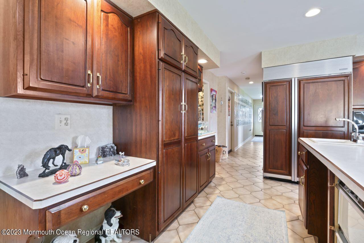 111 Muhlenbrink Road Colts Neck, NJ 07722 - Photo 23 of 73 a kitchen with stainless steel appliances granite countertop a refrigerator and a sink