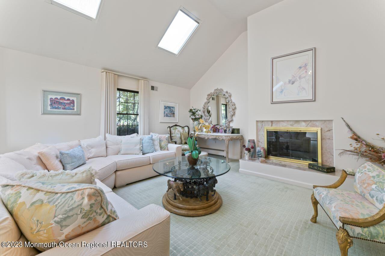 111 Muhlenbrink Road Colts Neck, NJ 07722 - Photo 36 of 73 a living room with furniture a window and a fireplace