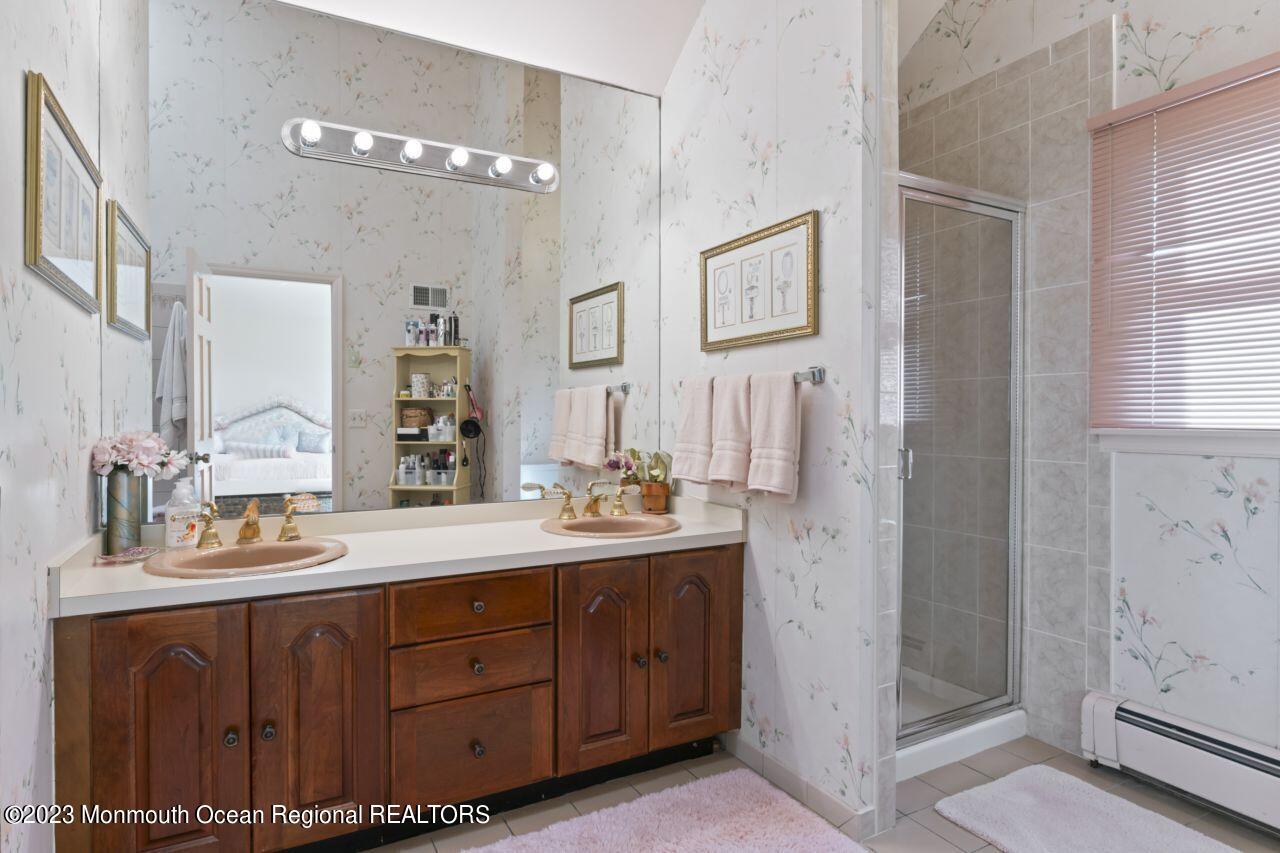 111 Muhlenbrink Road Colts Neck, NJ 07722 - Photo 39 of 73 a bathroom with a double vanity sink and mirror