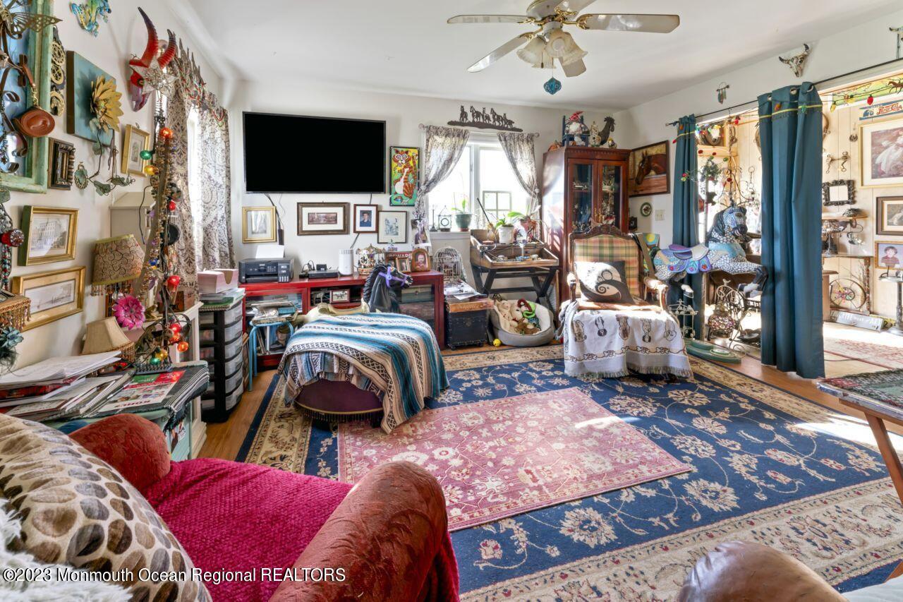 111 Muhlenbrink Road Colts Neck, NJ 07722 - Photo 70 of 73 a living room with furniture a flat screen tv and a large window
