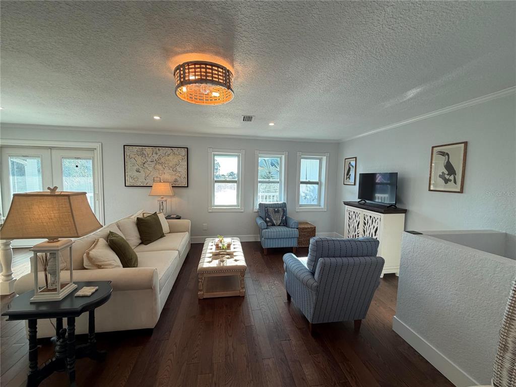 6525 Engram Road New Smyrna Beach, FL 32169 - Photo 18 of 36 a living room with furniture and a wooden floor