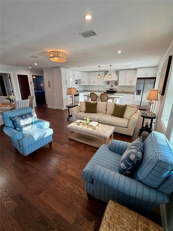 6525 Engram Road New Smyrna Beach, FL 32169 - Photo 19 of 36 a living room with furniture kitchen view and a wooden floor