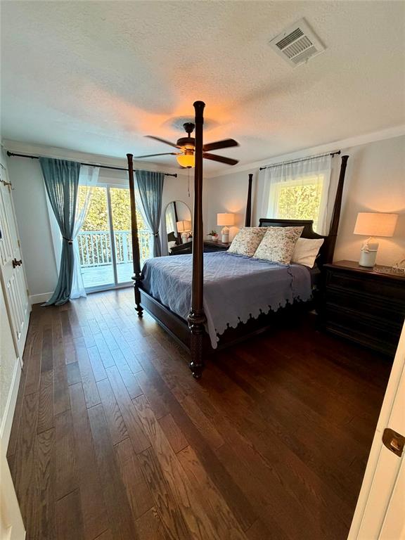 6525 Engram Road New Smyrna Beach, FL 32169 - Photo 30 of 36 a bedroom with a bed large window with wooden floor