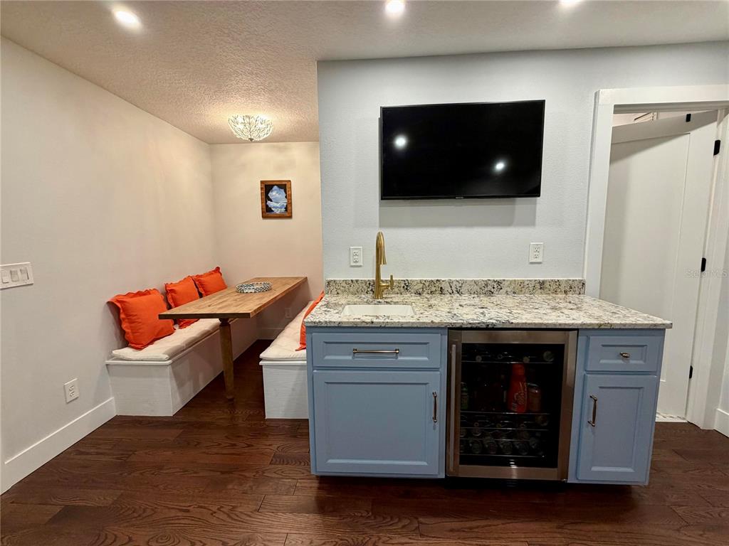 6525 Engram Road New Smyrna Beach, FL 32169 - Photo 10 of 36 a living room with a sink and a fireplace with wooden floor