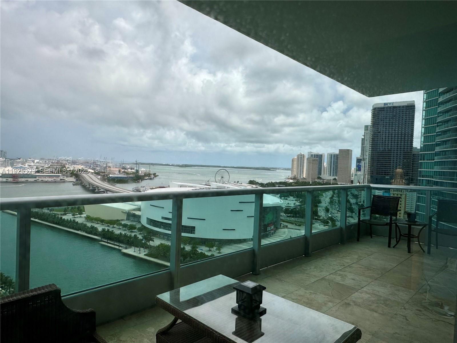 900 Biscayne Boulevard, Unit 2604 Miami, FL 33132 - Photo 11 of 59 a view of a swimming pool with a table in chairs