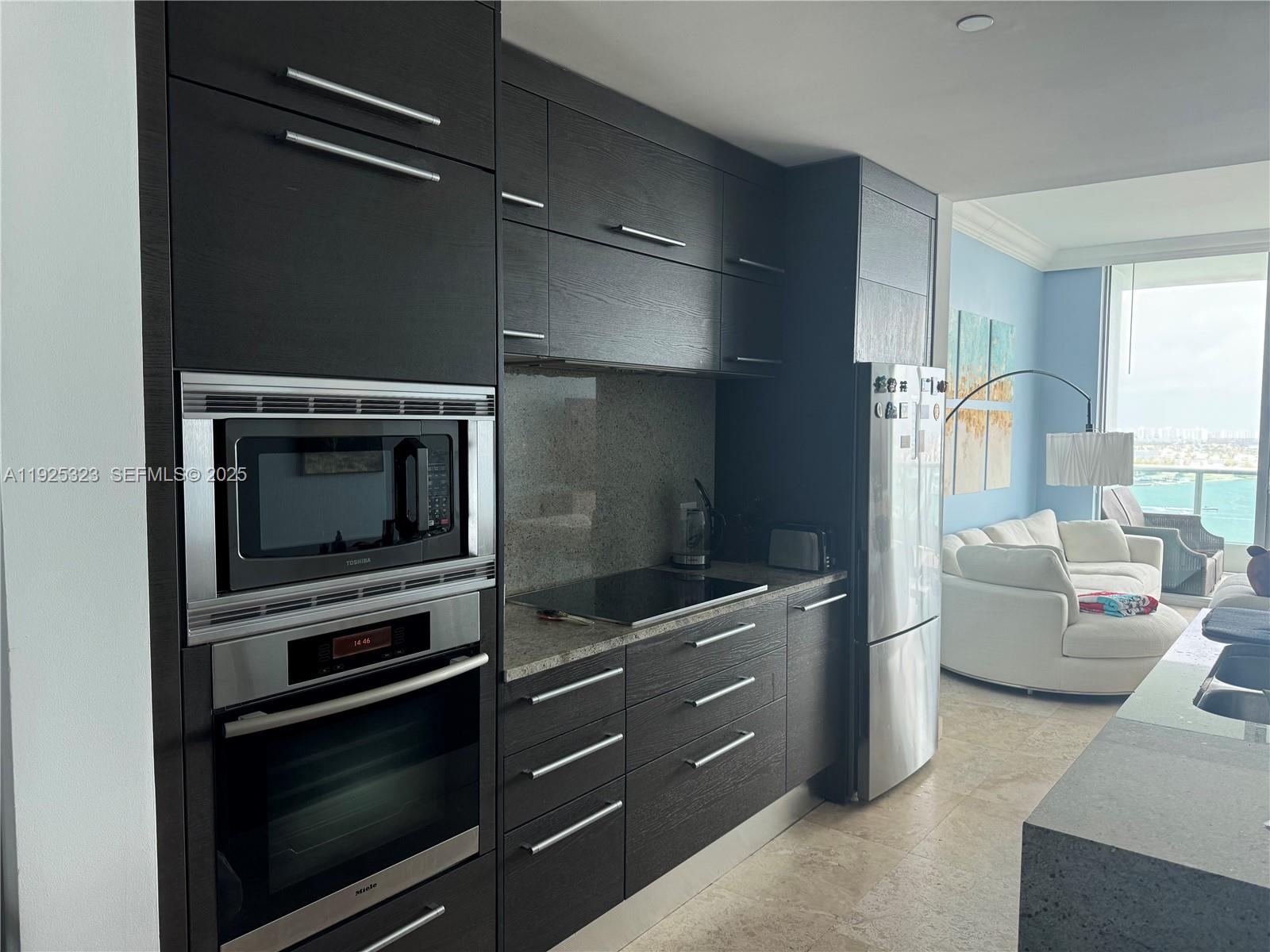 900 Biscayne Boulevard, Unit 2604 Miami, FL 33132 - Photo 15 of 59 a kitchen with a stove and a microwave