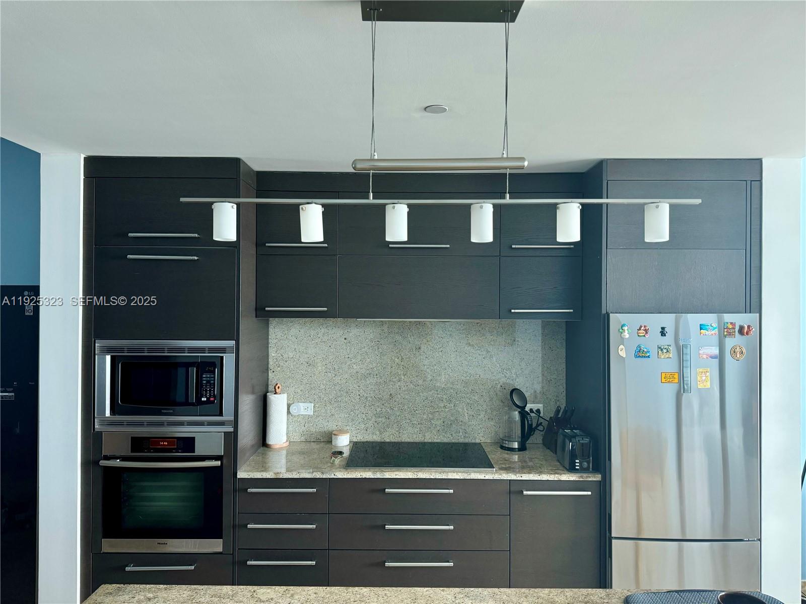 900 Biscayne Boulevard, Unit 2604 Miami, FL 33132 - Photo 16 of 59 a kitchen with a sink and a refrigerator