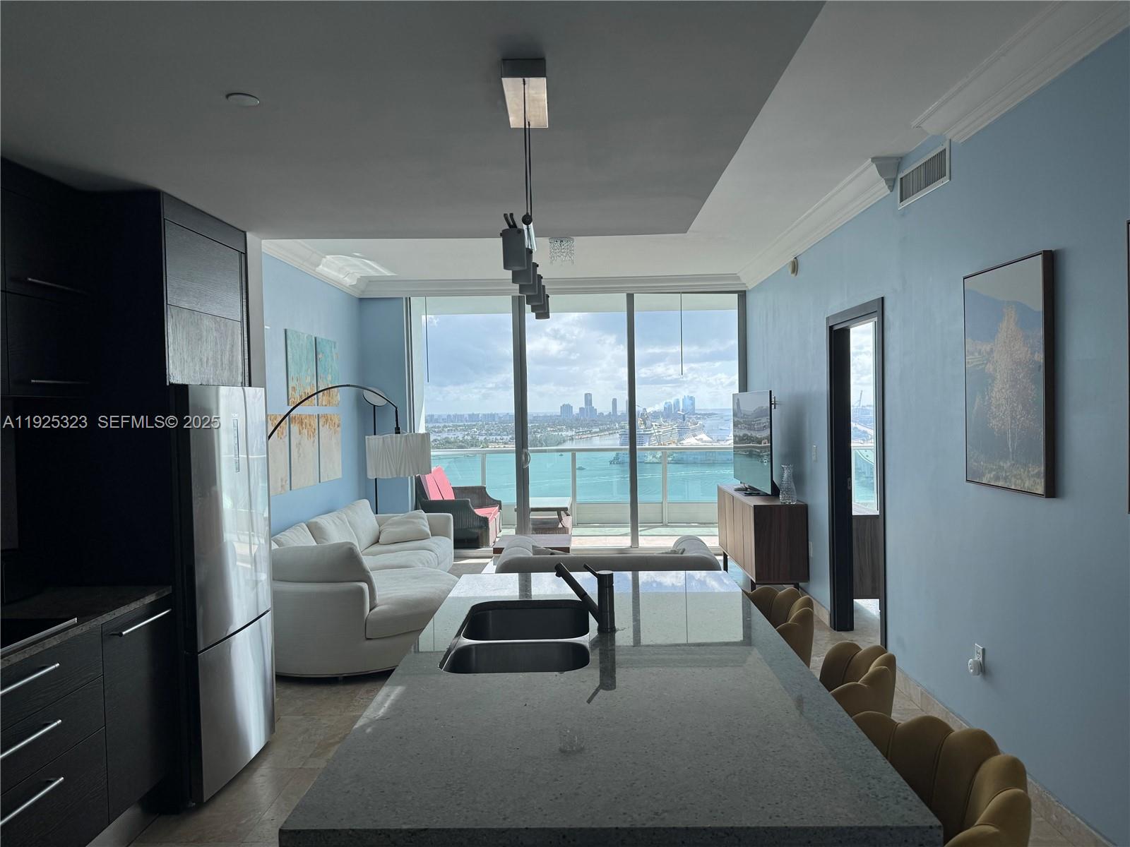 900 Biscayne Boulevard, Unit 2604 Miami, FL 33132 - Photo 17 of 59 a living room with furniture and a flat screen tv