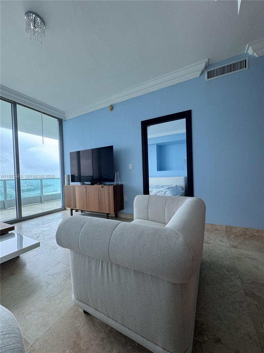 900 Biscayne Boulevard, Unit 2604 Miami, FL 33132 - Photo 29 of 59 a living room with furniture and a flat screen tv