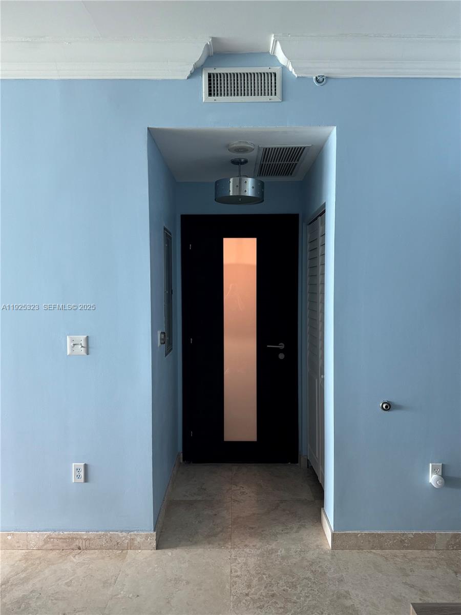 900 Biscayne Boulevard, Unit 2604 Miami, FL 33132 - Photo 33 of 59 a view of a hallway with wooden cabinets