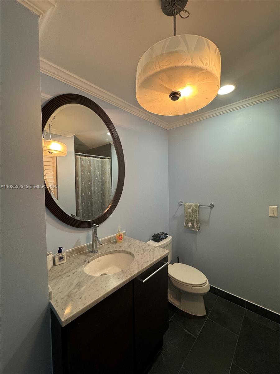900 Biscayne Boulevard, Unit 2604 Miami, FL 33132 - Photo 34 of 59 a bathroom with a sink a toilet and a mirror