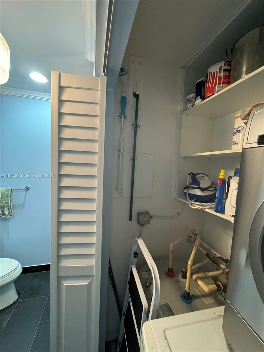 900 Biscayne Boulevard, Unit 2604 Miami, FL 33132 - Photo 36 of 59 a bathroom with a sink a toilet and a mirror