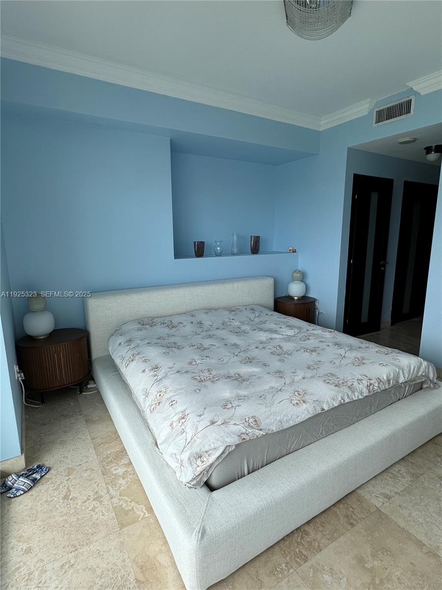900 Biscayne Boulevard, Unit 2604 Miami, FL 33132 - Photo 47 of 59 a bedroom with a bed and a couch