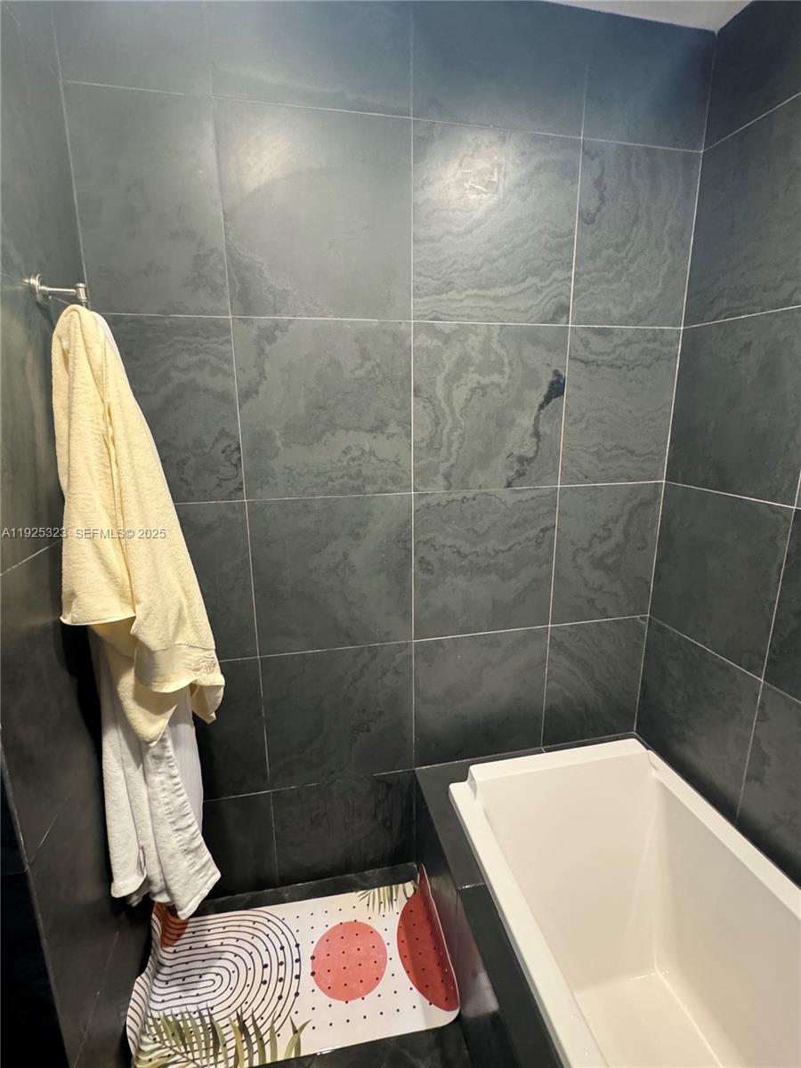900 Biscayne Boulevard, Unit 2604 Miami, FL 33132 - Photo 55 of 59 a bathroom with a bathtub and shower