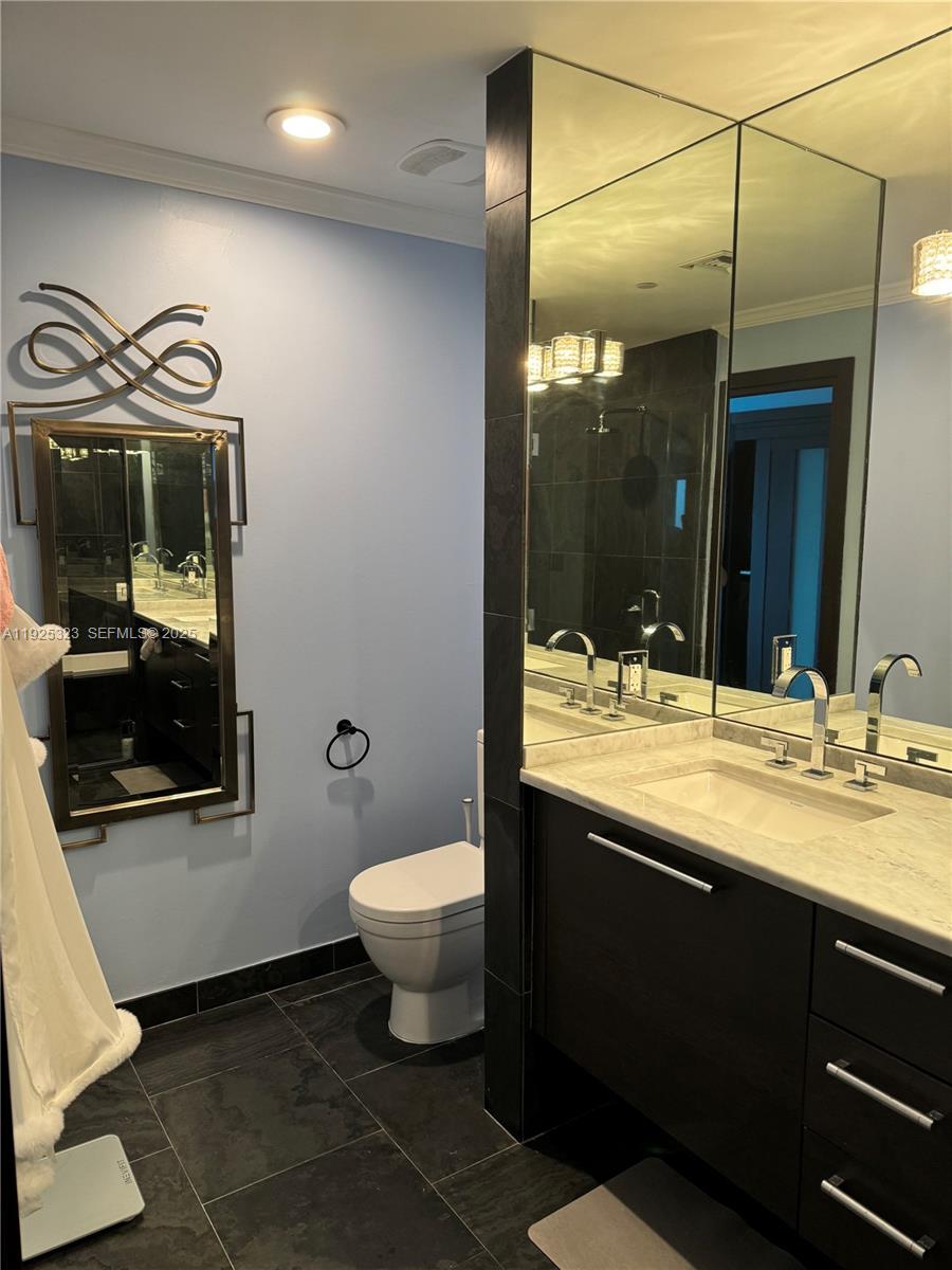 900 Biscayne Boulevard, Unit 2604 Miami, FL 33132 - Photo 56 of 59 a bathroom with a toilet sink and mirror