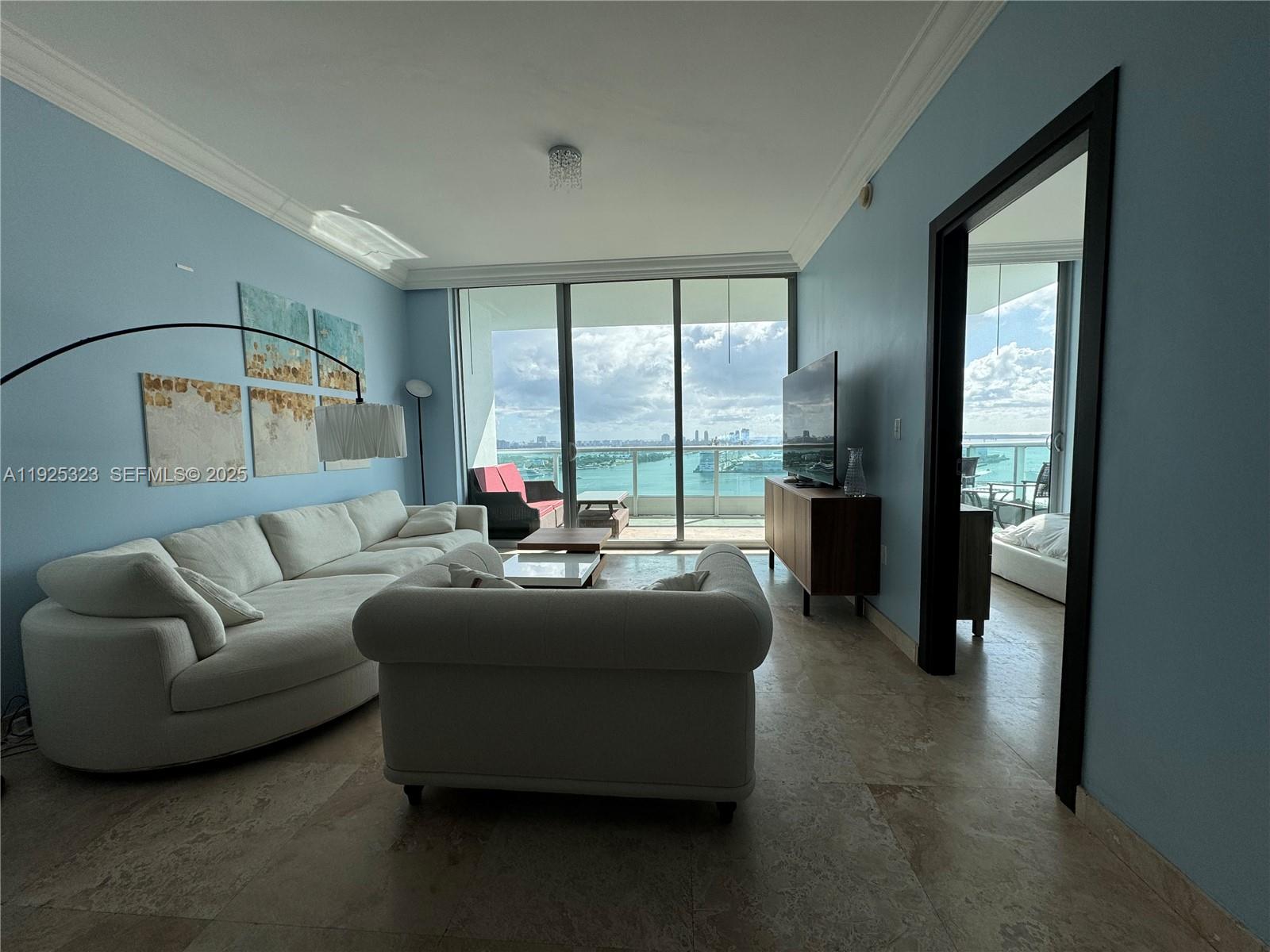 900 Biscayne Boulevard, Unit 2604 Miami, FL 33132 - Photo 8 of 59 a living room with furniture and a large window