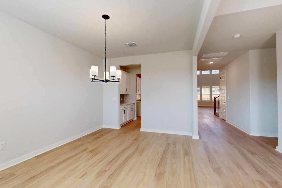 3965 Waco Way Leander, TX 78641 - Photo 14 of 38 a view of a kitchen with wooden floor and a ceiling fan