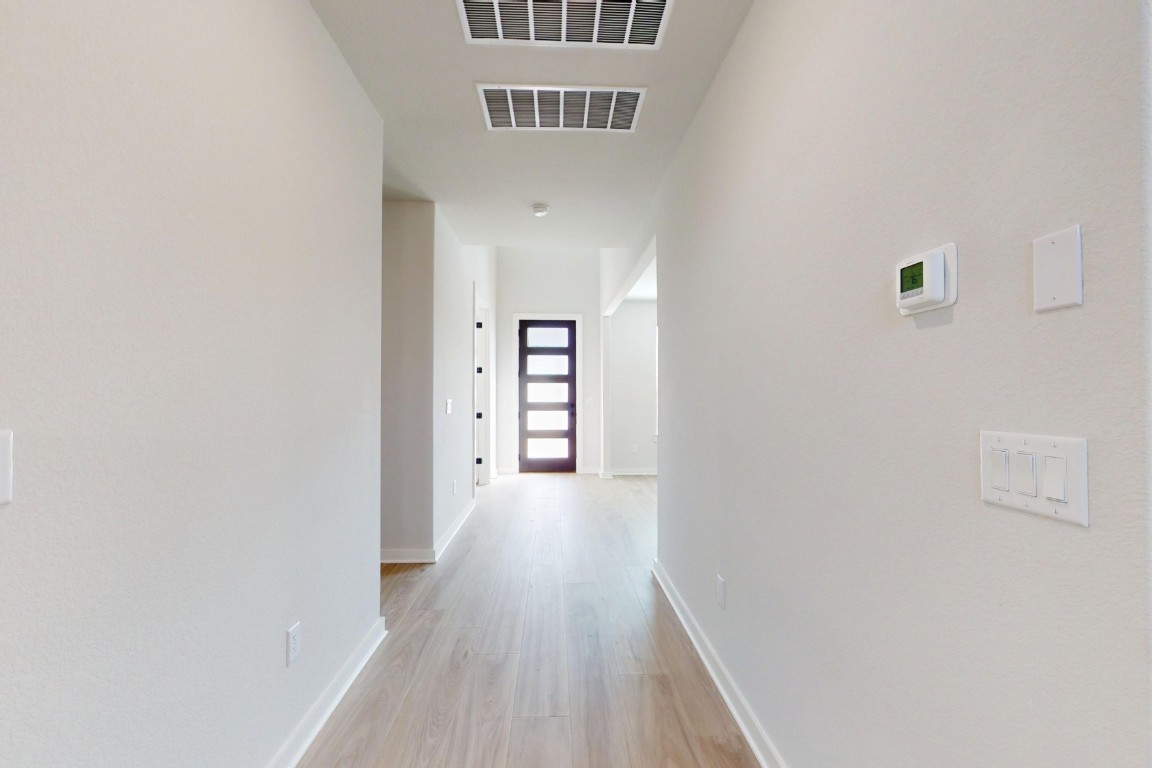 3965 Waco Way Leander, TX 78641 - Photo 15 of 38 a view of a hallway with wooden floor
