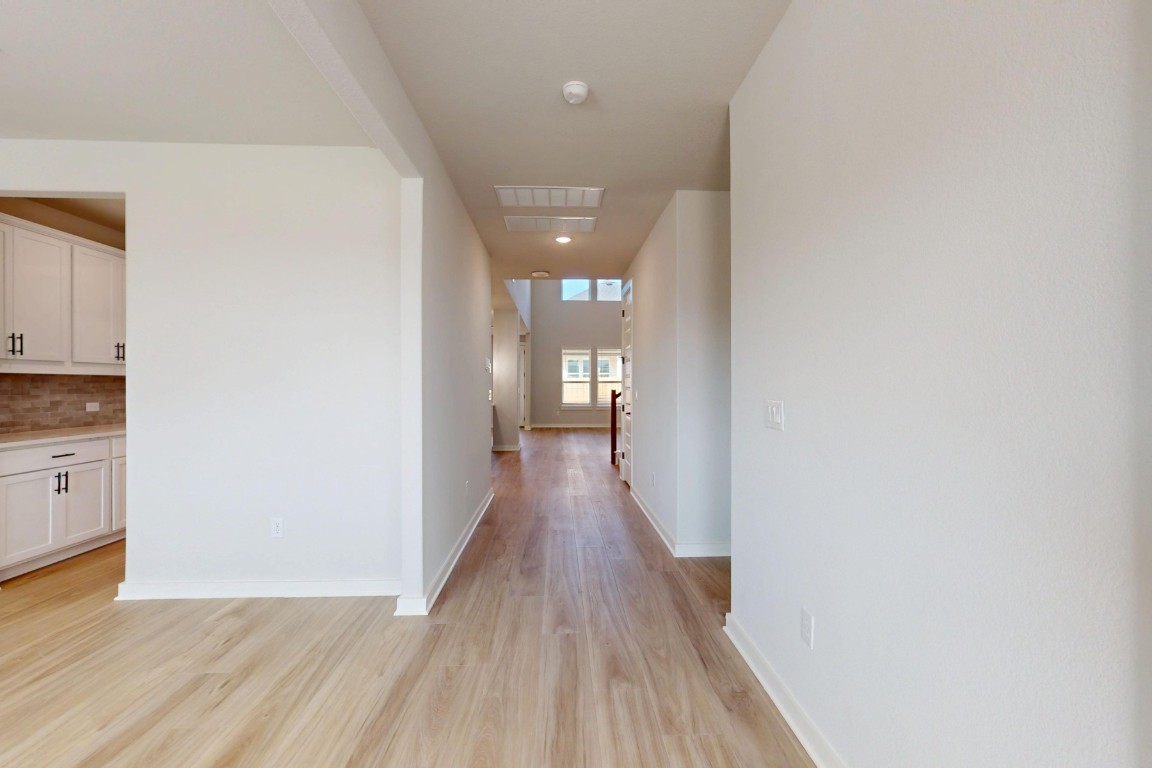 3965 Waco Way Leander, TX 78641 - Photo 16 of 38 a view of a hallway with wooden floor