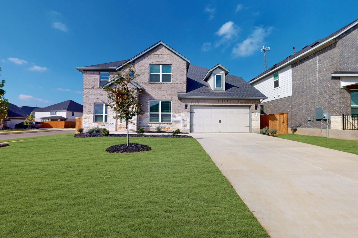 3965 Waco Way Leander, TX 78641 - Photo 2 of 38 a front view of a house with a yard