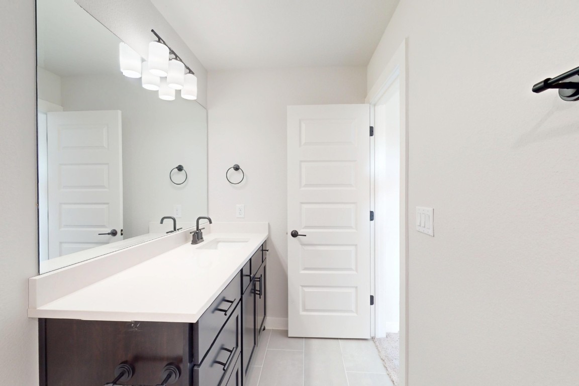 3965 Waco Way Leander, TX 78641 - Photo 28 of 38 a bathroom with a sink a vanity and a mirror