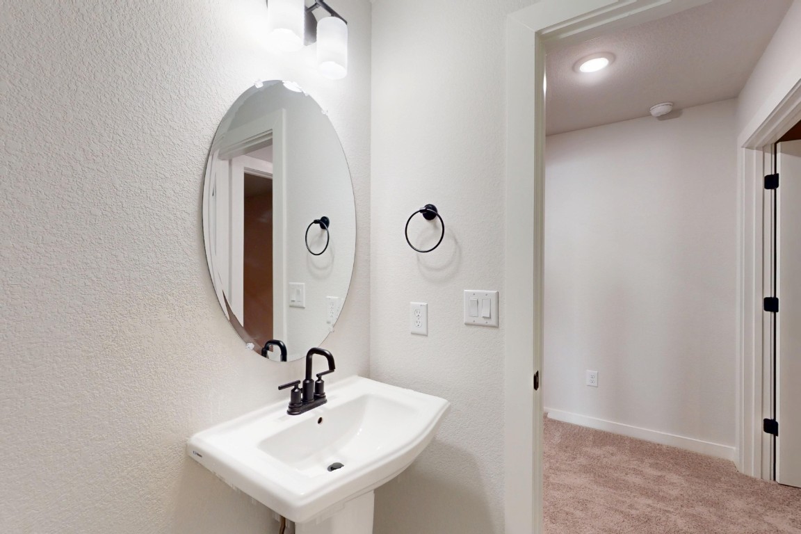 3965 Waco Way Leander, TX 78641 - Photo 31 of 38 a bathroom with a sink and mirror