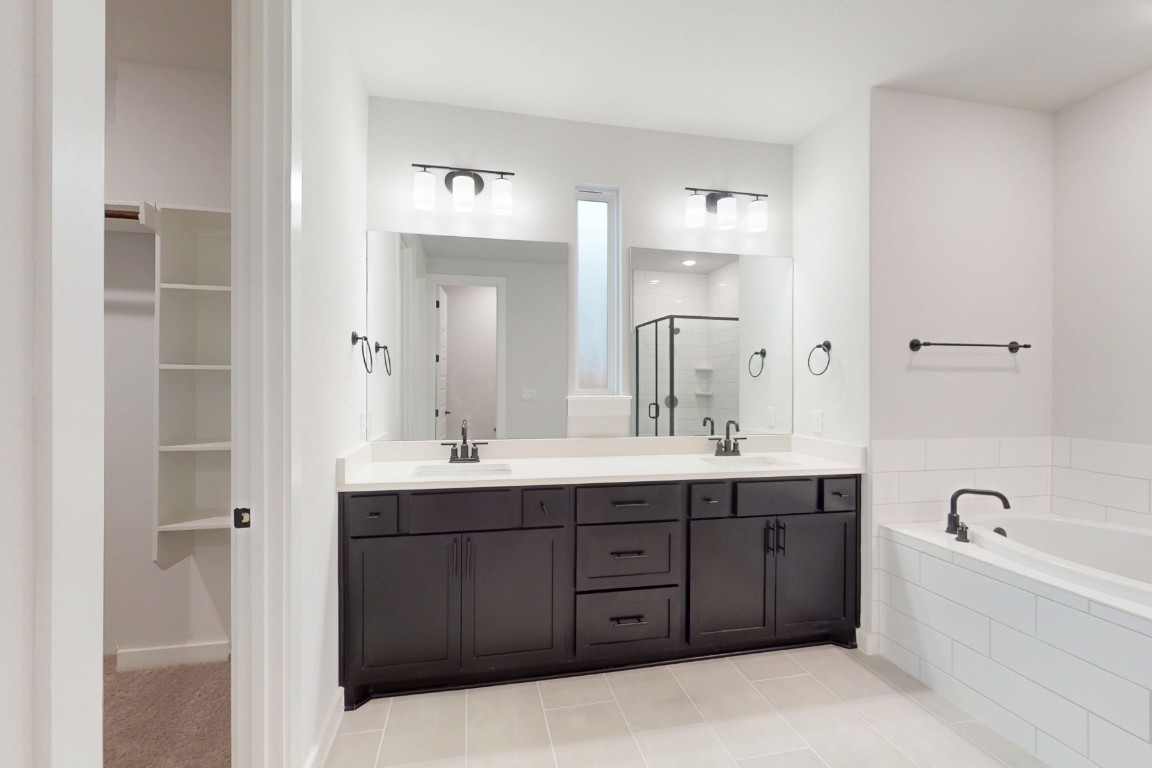 3965 Waco Way Leander, TX 78641 - Photo 33 of 38 a spacious bathroom with a tub double sink and mirror