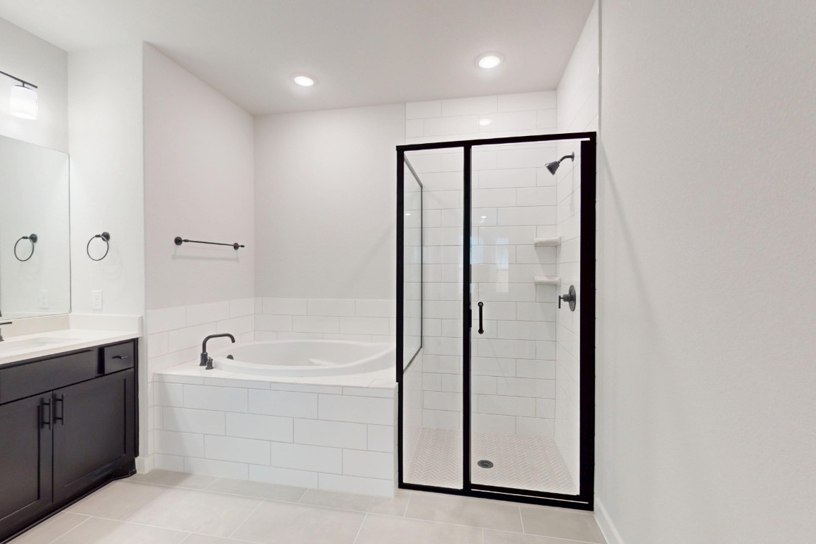 3965 Waco Way Leander, TX 78641 - Photo 34 of 38 a bathroom with a bathtub and a shower