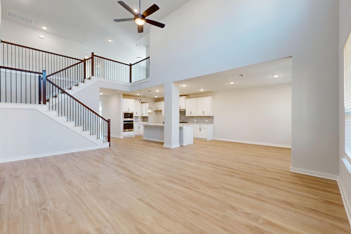3965 Waco Way Leander, TX 78641 - Photo 5 of 38 a view of empty room with wooden floor and fan