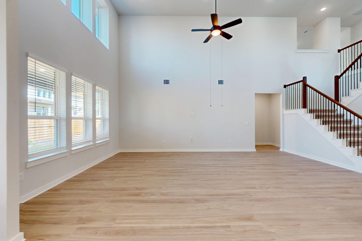 3965 Waco Way Leander, TX 78641 - Photo 6 of 38 a view of an empty room with wooden floor and a window