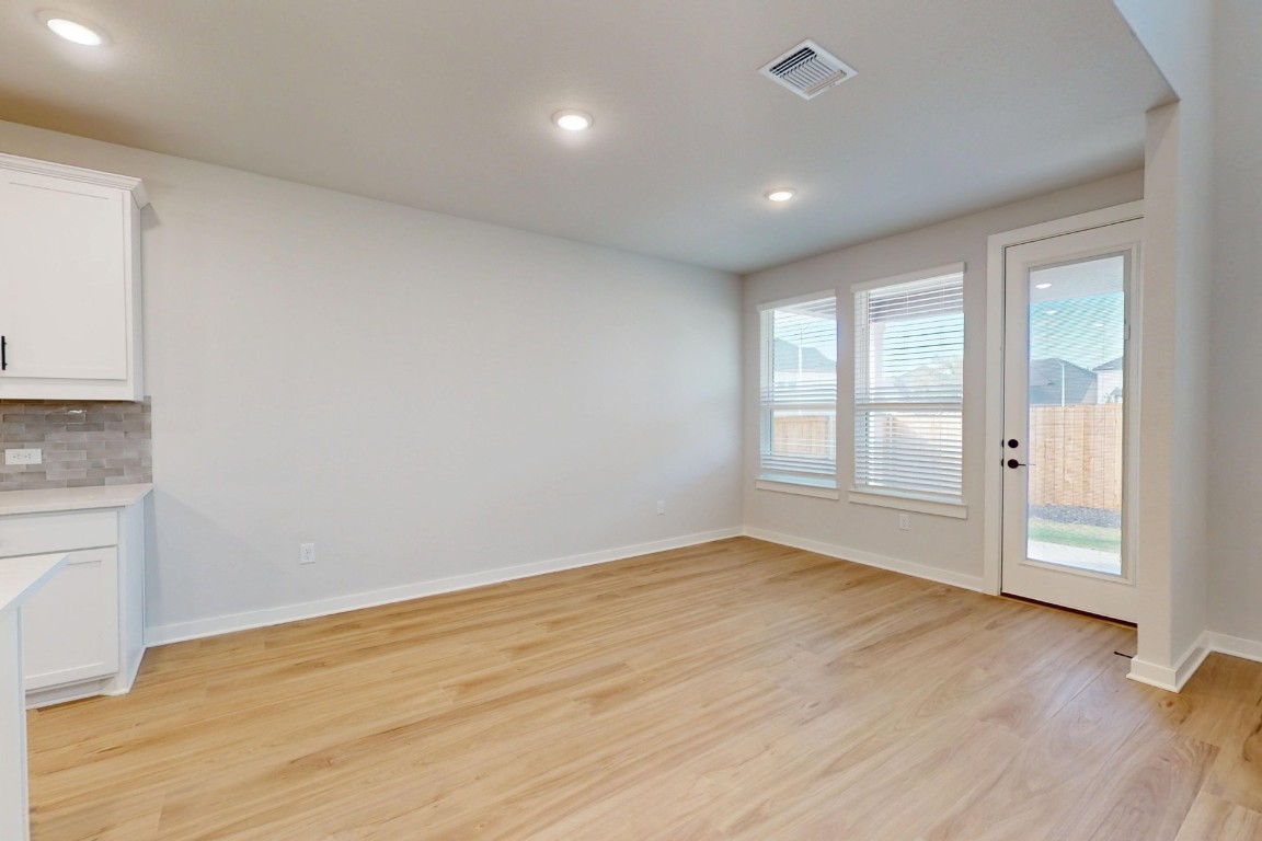 3965 Waco Way Leander, TX 78641 - Photo 8 of 38 wooden floor in an empty room with a window