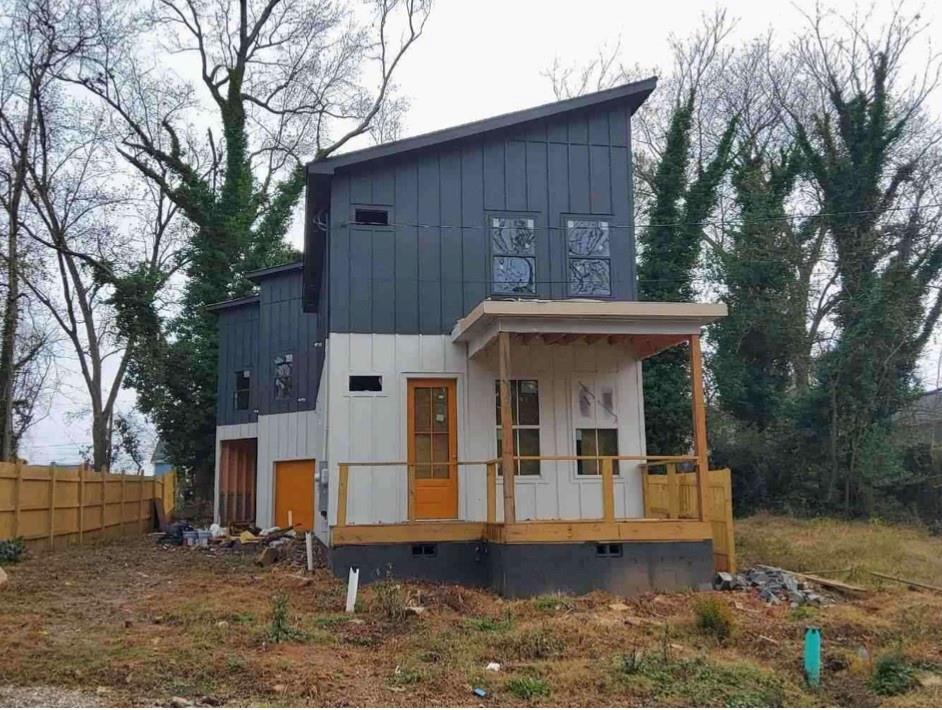 1148 Welch Street Southwest Atlanta, GA 30310 - Photo 1 of 4 a view of a house with large trees and wooden fence