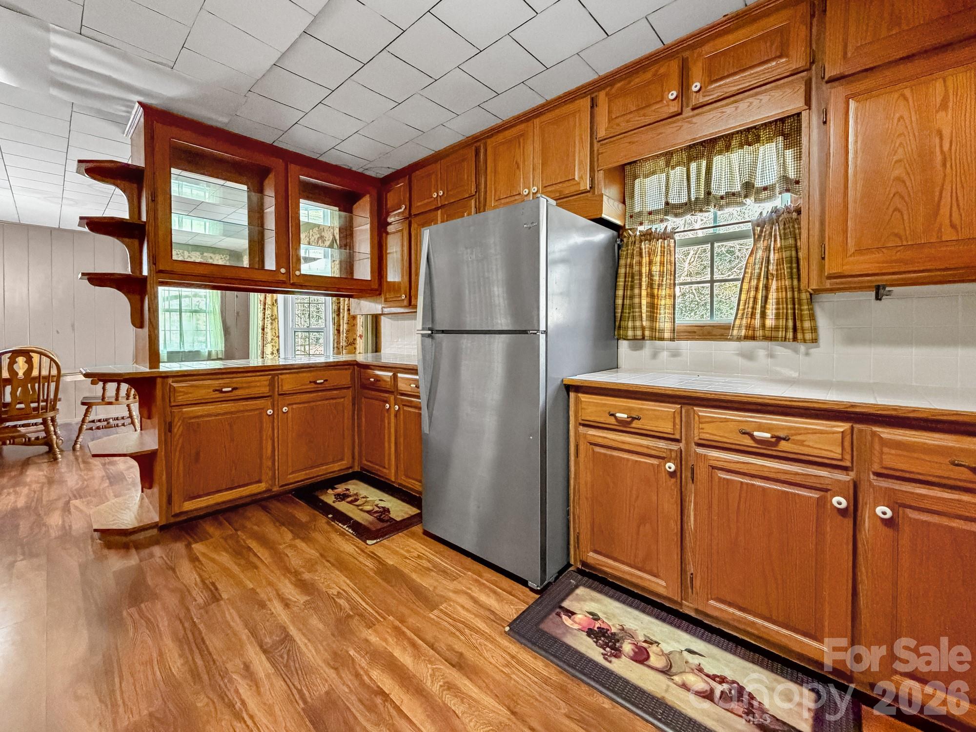 1401 East Union Street Morganton, NC 28655 - Photo 13 of 40 a kitchen with stainless steel appliances granite countertop a refrigerator a stove a sink dishwasher and wooden cabinets with wooden floor