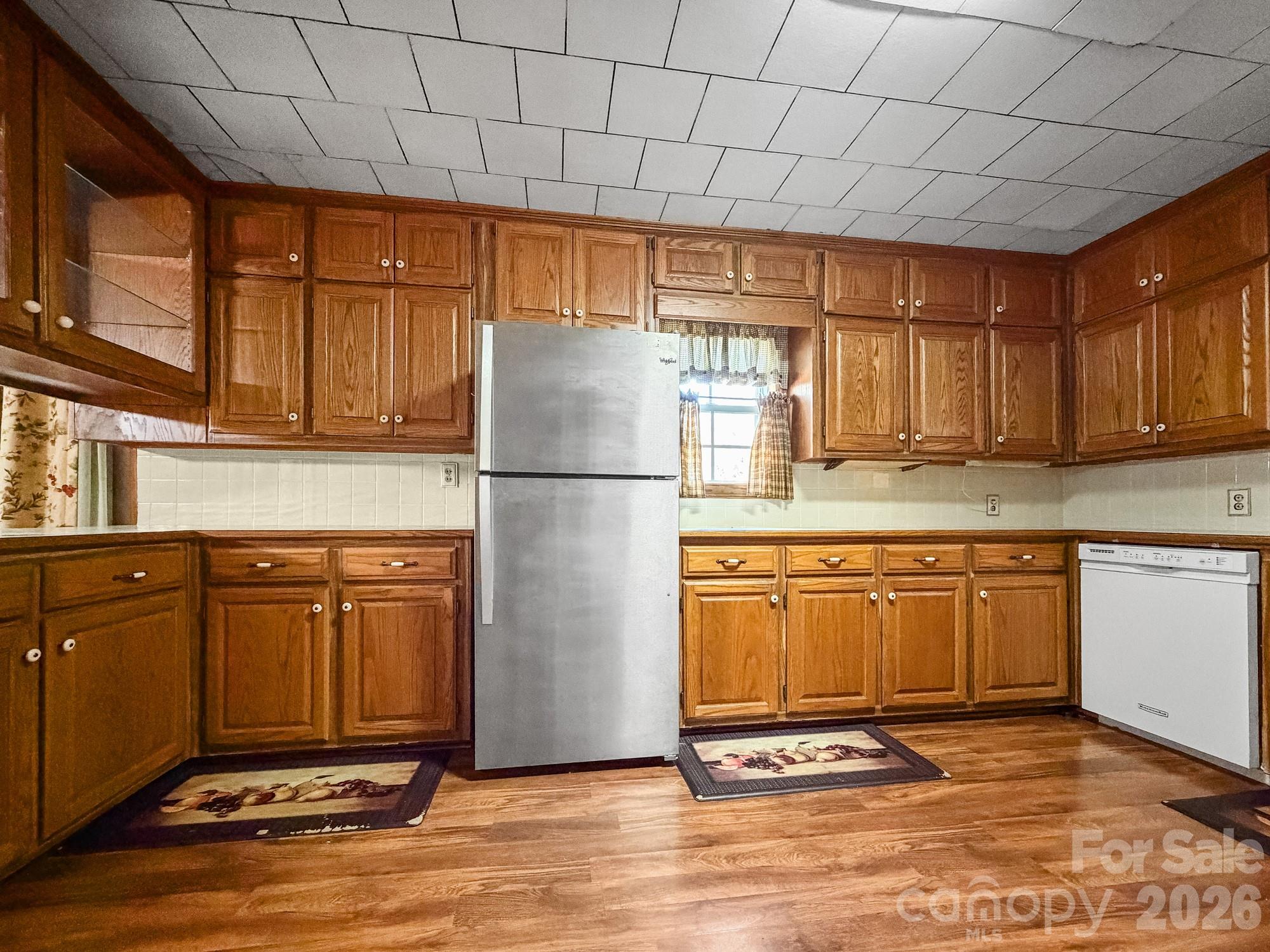 1401 East Union Street Morganton, NC 28655 - Photo 14 of 40 a kitchen with stainless steel appliances granite countertop a refrigerator a sink dishwasher and wooden cabinets with a granite countertops