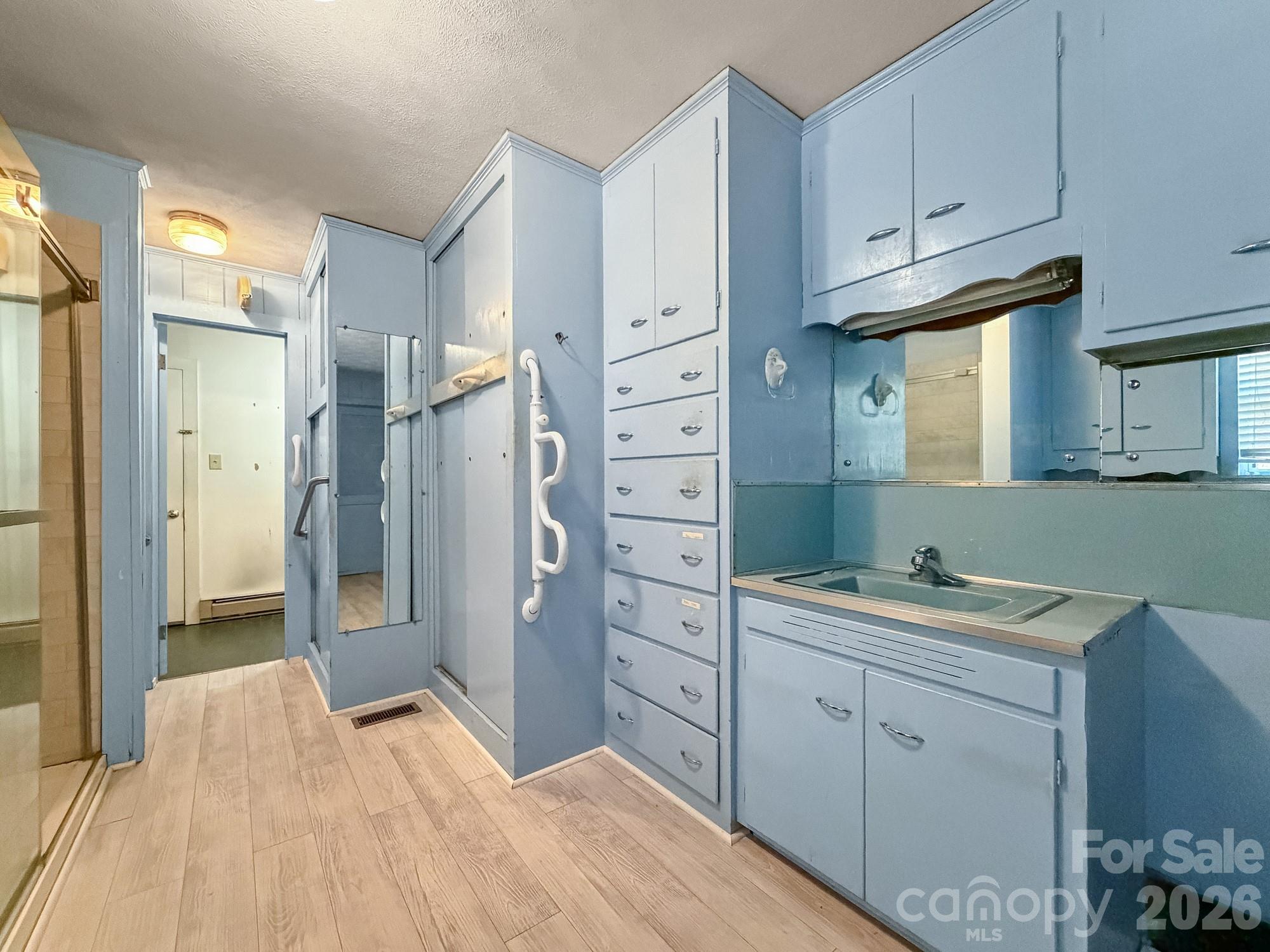 1401 East Union Street Morganton, NC 28655 - Photo 21 of 40 a spacious bathroom with a shower sink and mirror